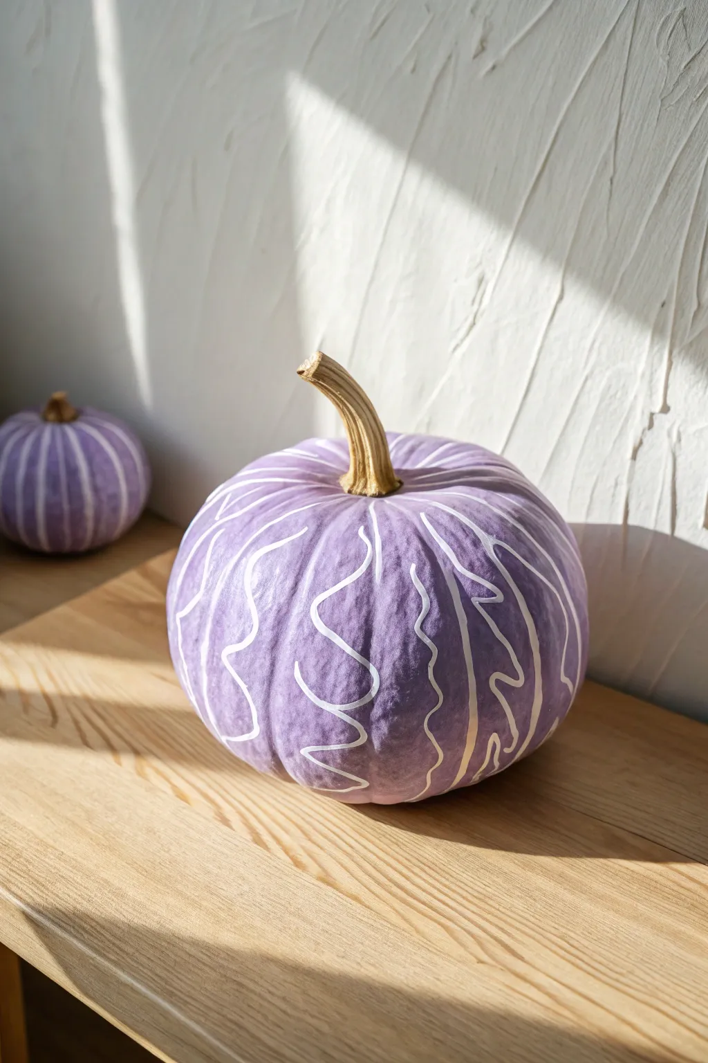 Lavender pumpkin with freeform white swirls, a minimalist boho statement for fall crafting.