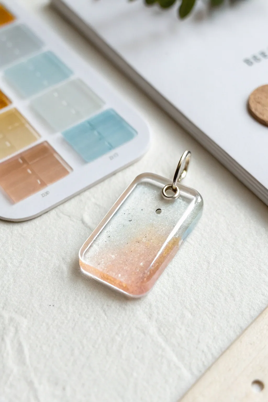 Simple tinted clear resin charm in pale blue, blush, and amber for minimalist boho DIY.