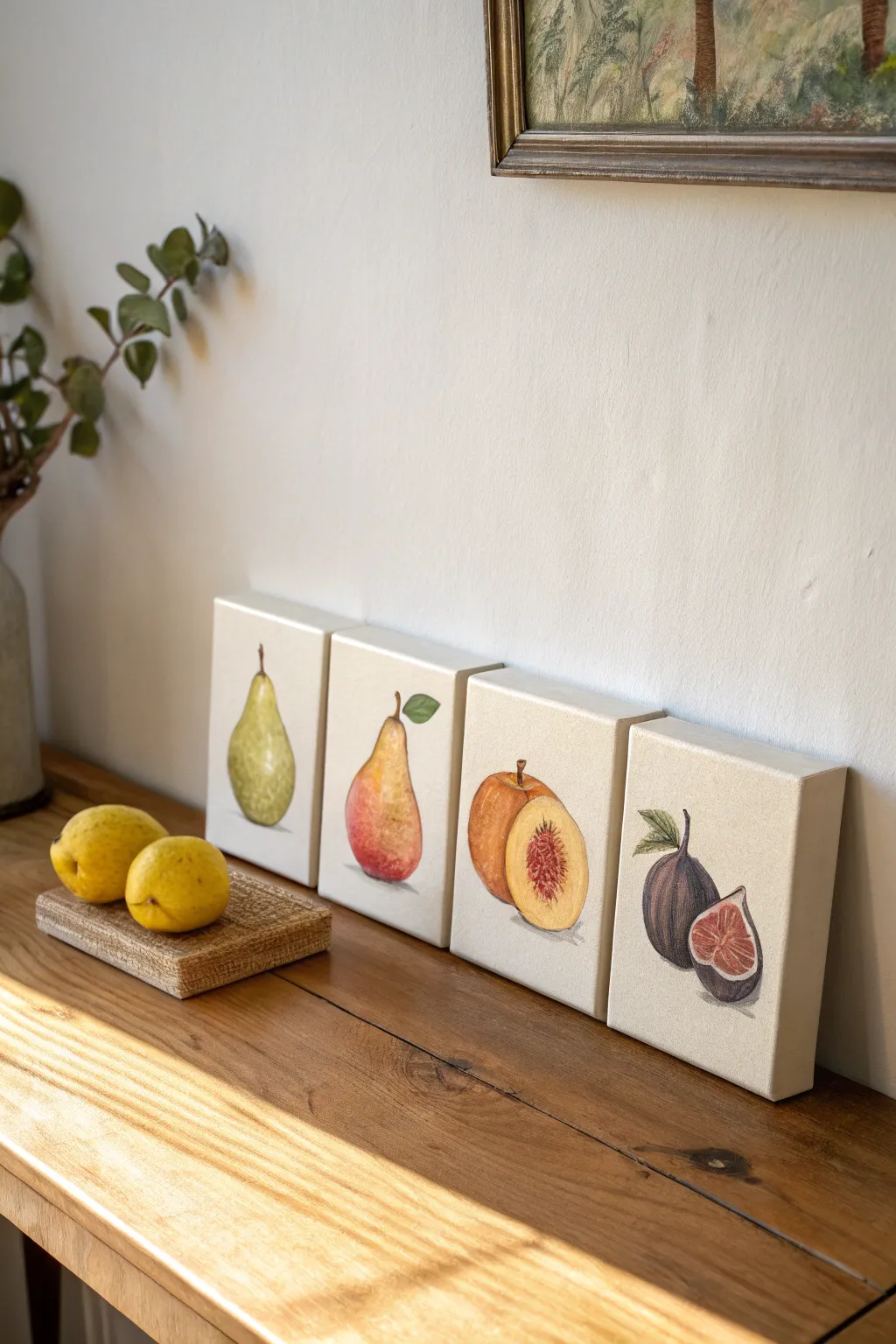 Simple fruit still life series: four cohesive canvases with matching light, shadows, and calm tones.