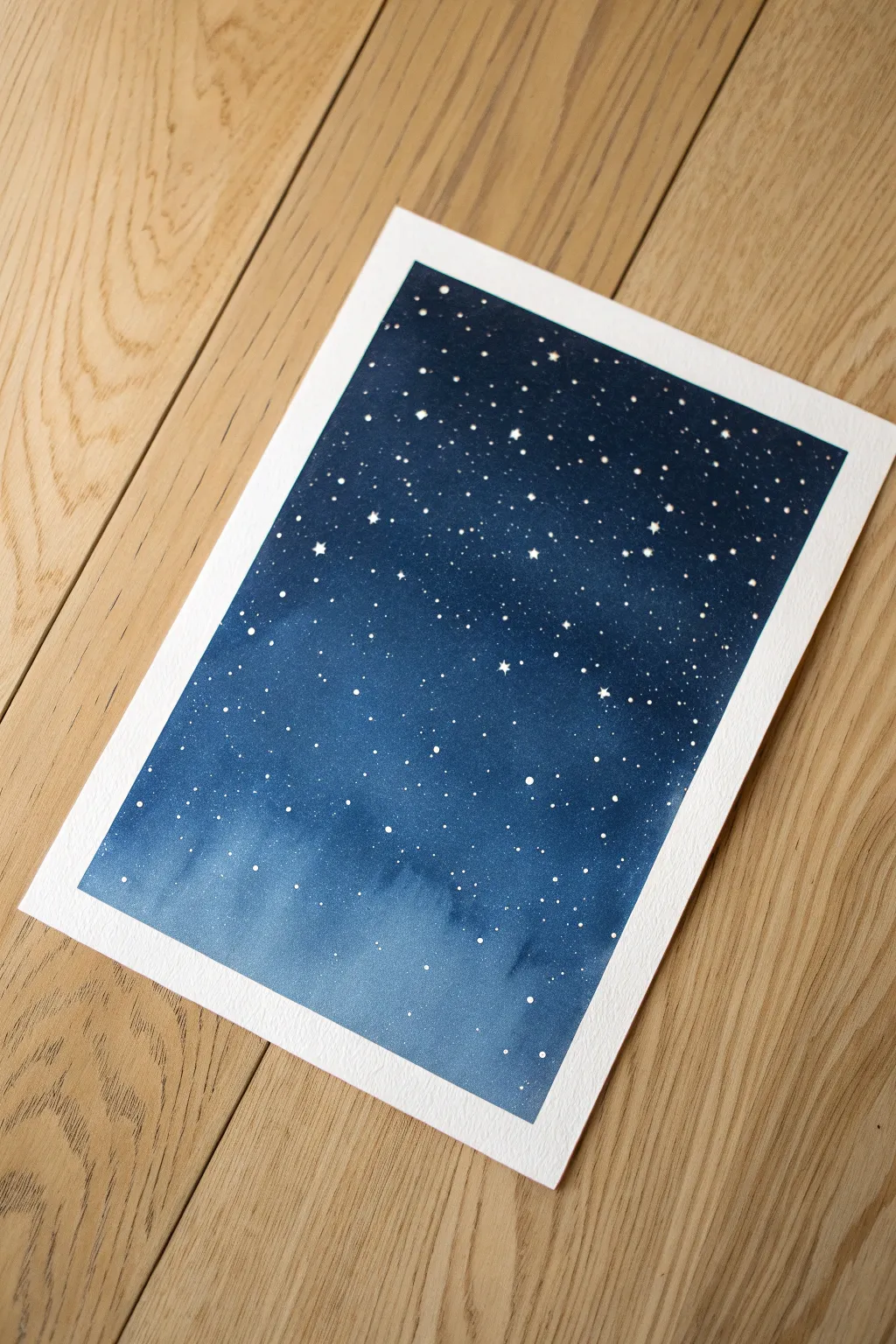 Minimal starry night splatter painting idea with deep indigo wash and a bright focal cluster