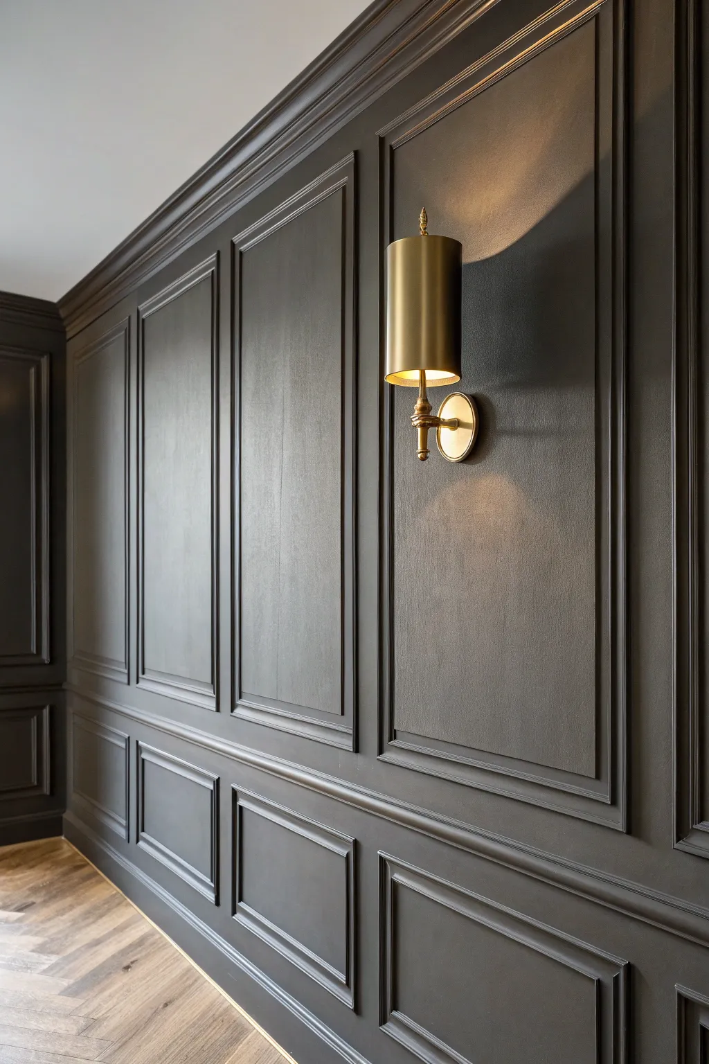 Monochrome trim-on-trim drenching: deep tones and warm sconce shadows for instant depth.