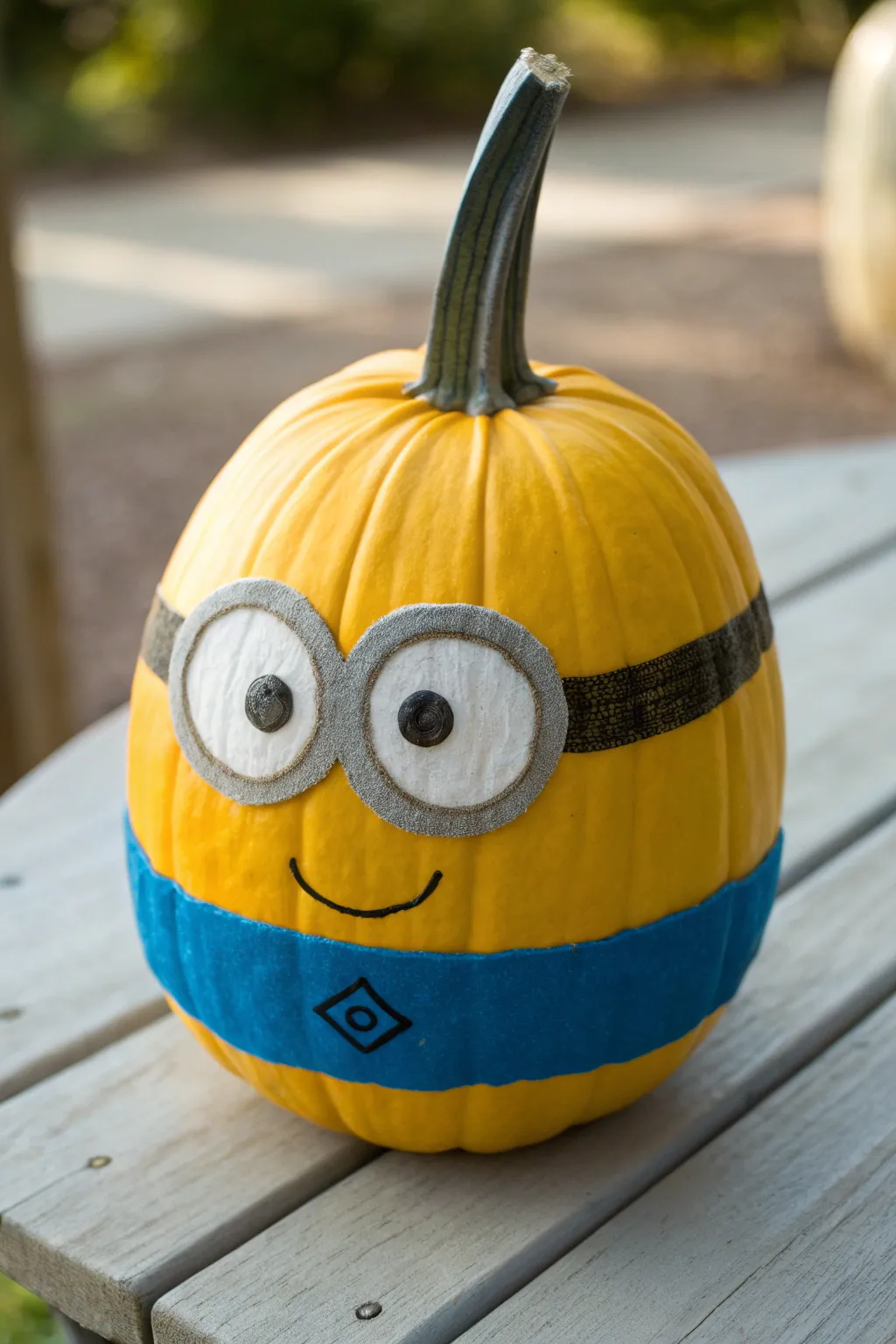 Cute yellow pumpkin in blue overalls with goggle eyes, minimalist boho DIY inspiration.