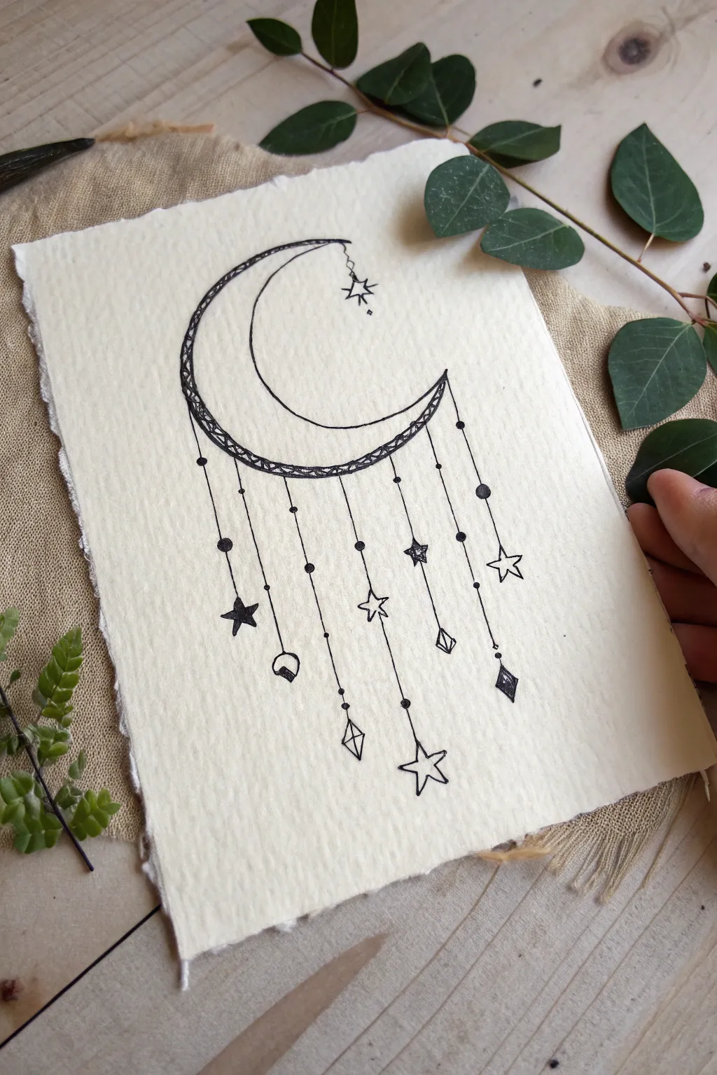 Dreamy crescent moon mobile drawing with hanging stars, minimalist Scandinavian boho vibe