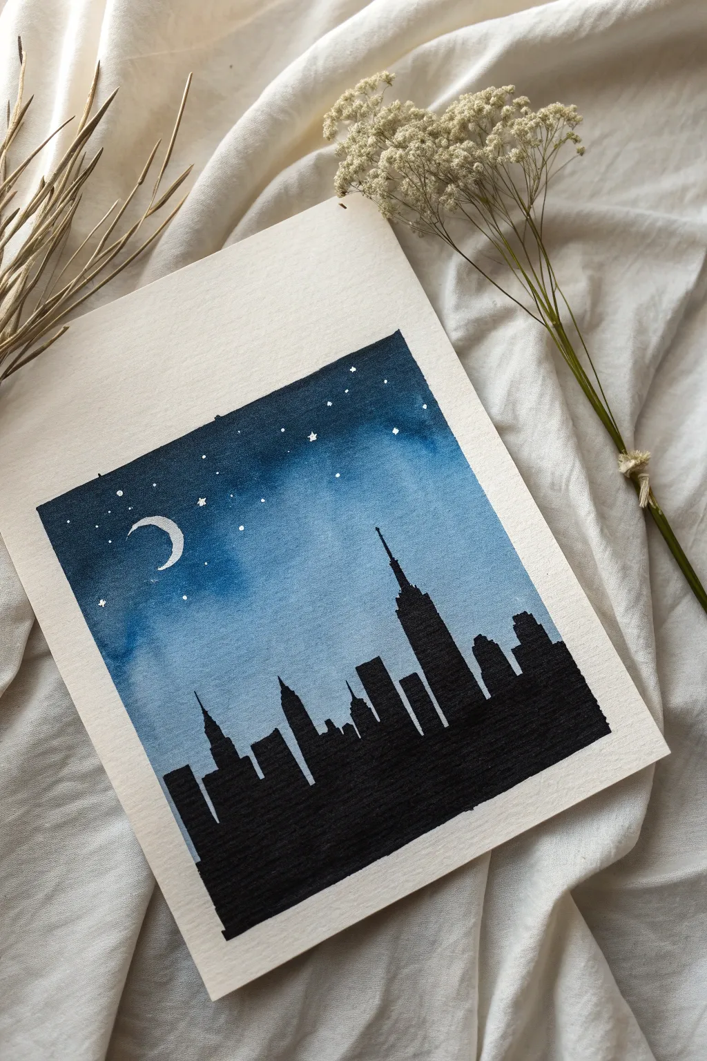 Minimal black skyline silhouette on deep blue night wash, calm Scandinavian boho mood.