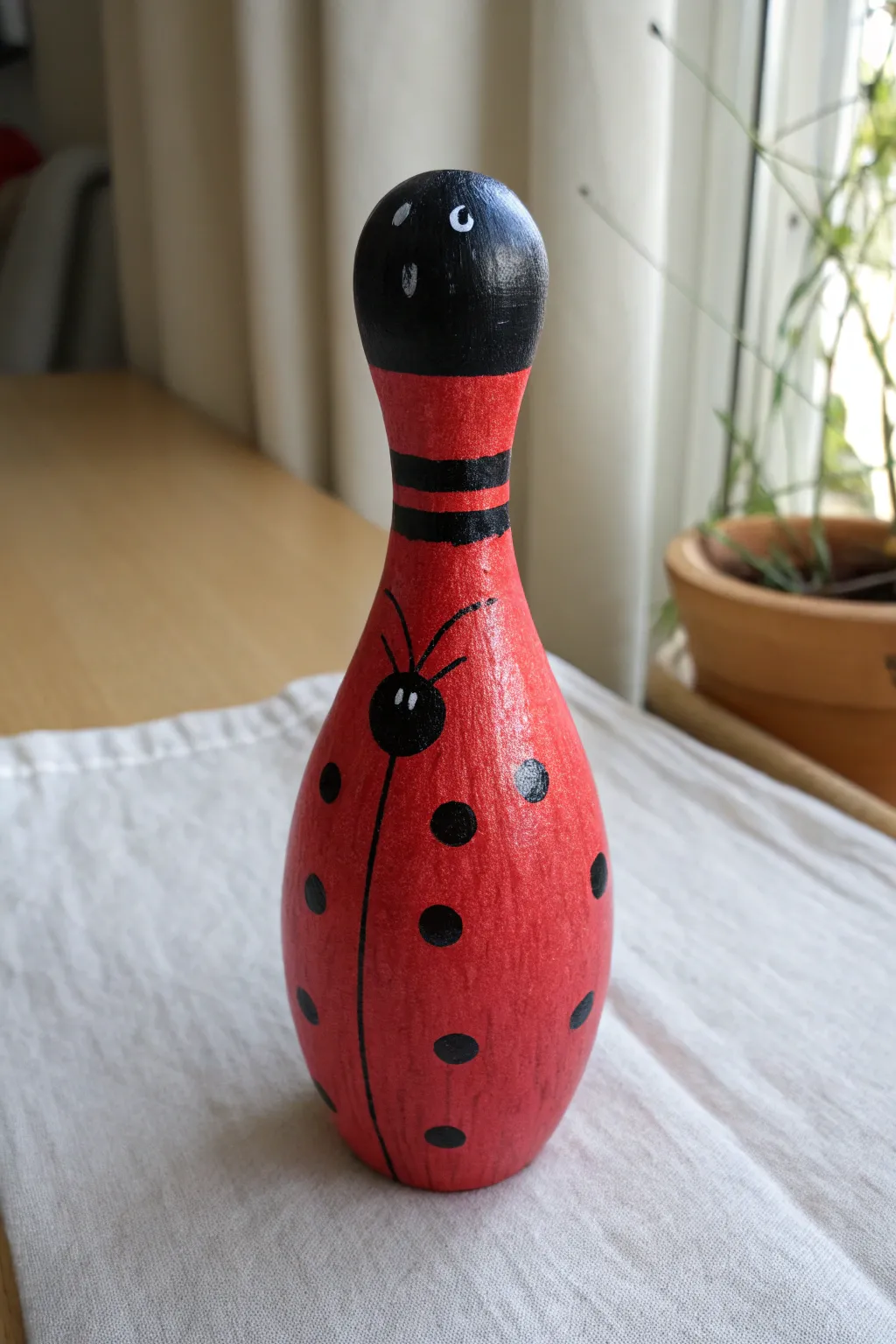 Paint a sweet ladybug bowling pin with bold dots and simple lines for instant charm.