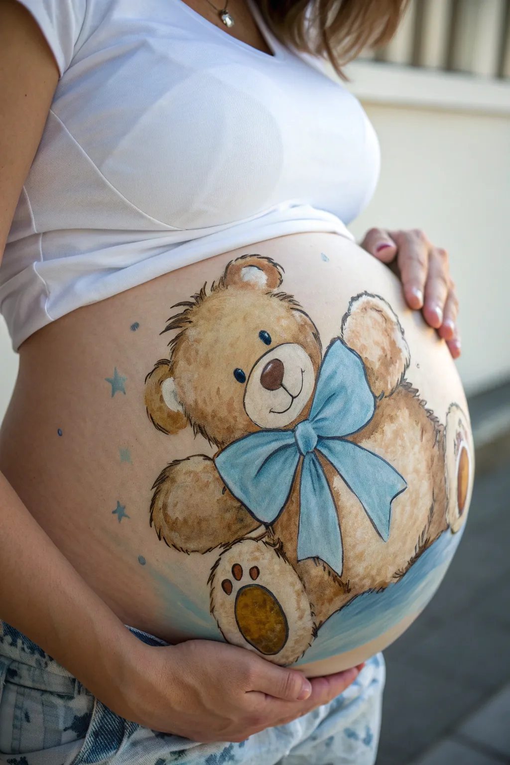 Sweet teddy bear belly art with a crisp blue bow tie, minimalist and baby boy themed.