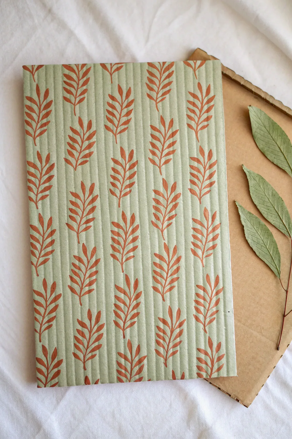 Leaf print cardboard painting with visible corrugation, minimalist boho palette, clean and serene