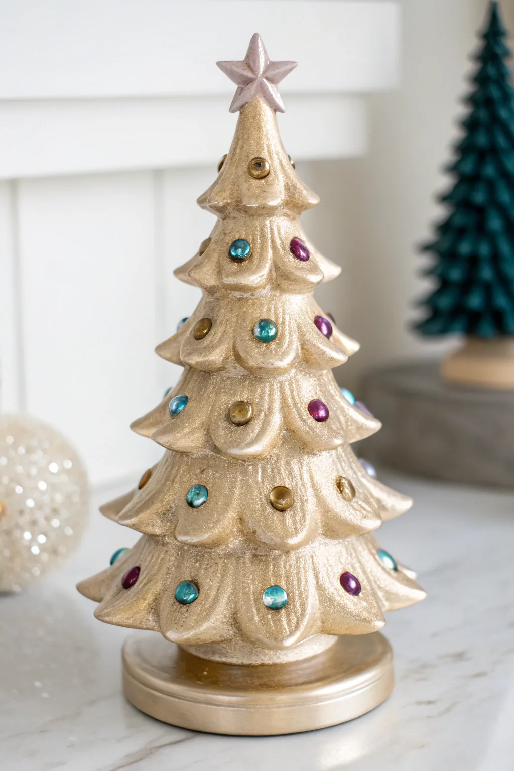 Metallic sheen ceramic Christmas tree with jewel bulbs for a chic, minimalist glam holiday look