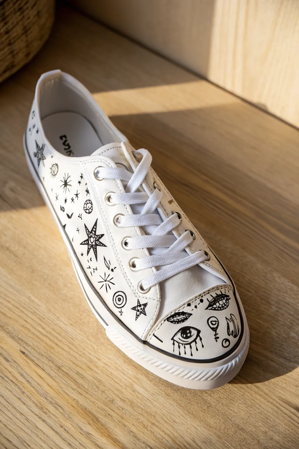 Minimal white sneaker with bold black doodle lines for chic monochrome shoe art inspiration.