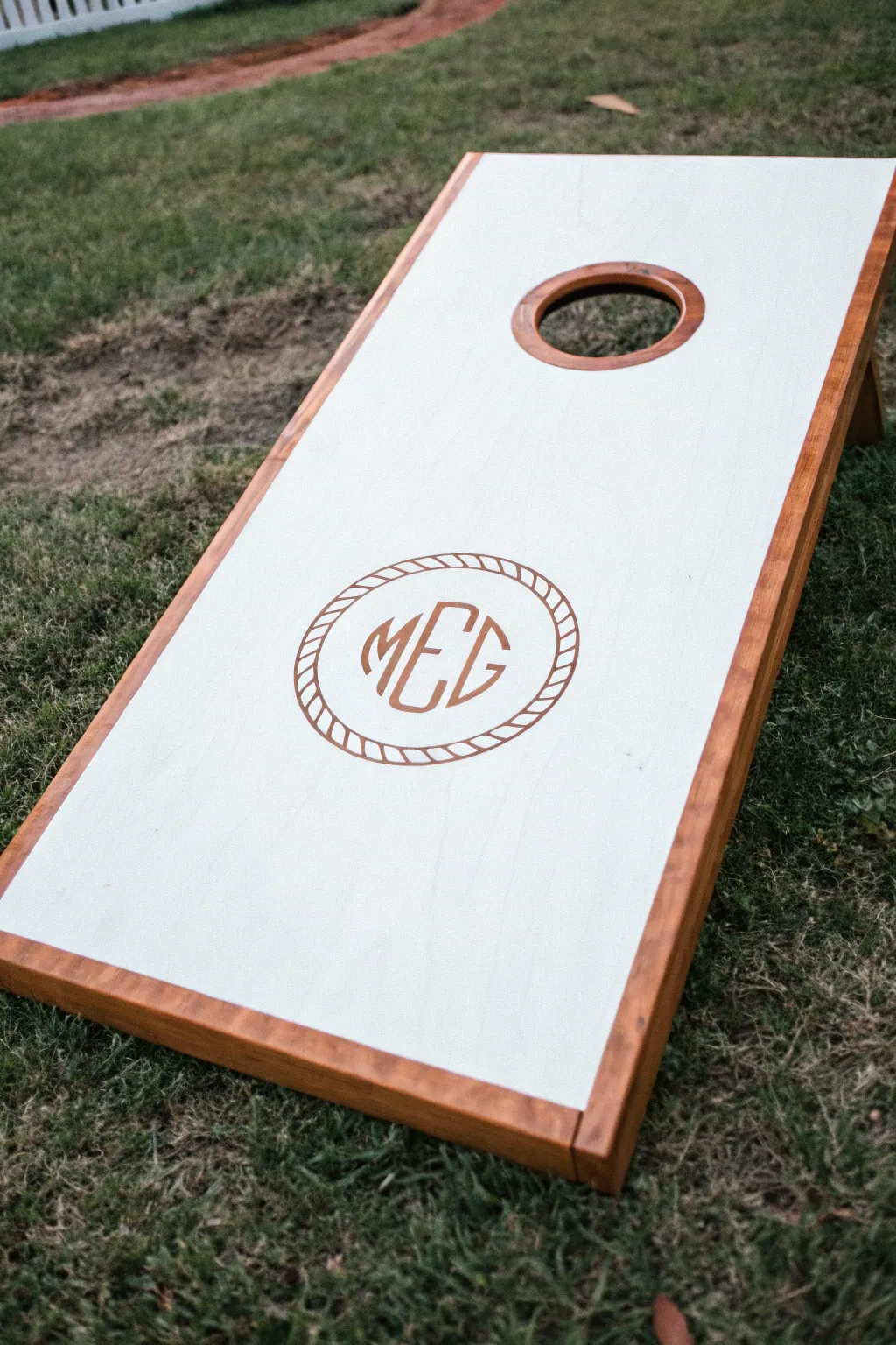 Minimal two-tone cornhole board with a ringed hole and elegant monogram emblem for calm style