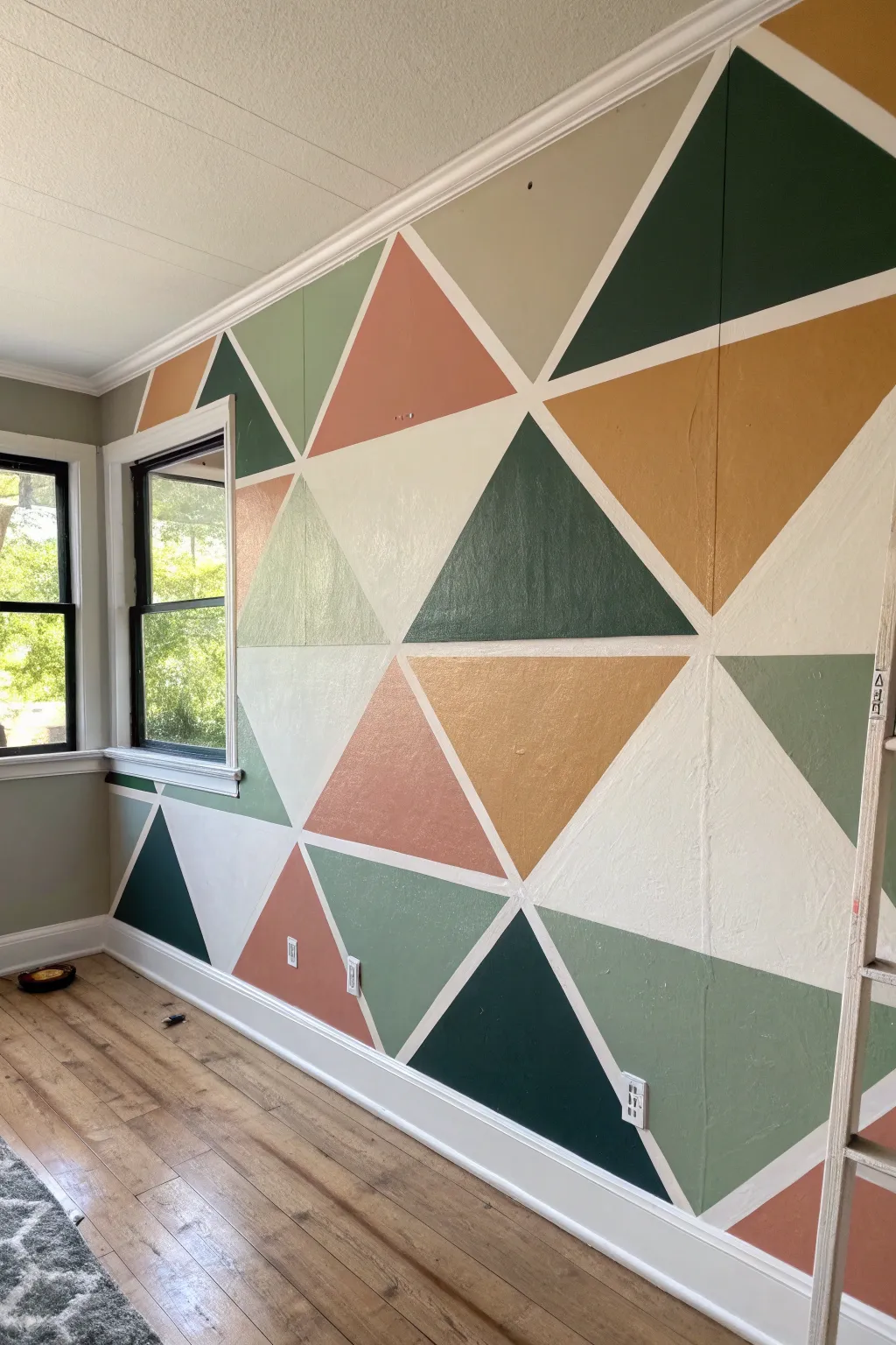 Modern tape triangle mural in soft boho neutrals, a clean Scandinavian statement wall.
