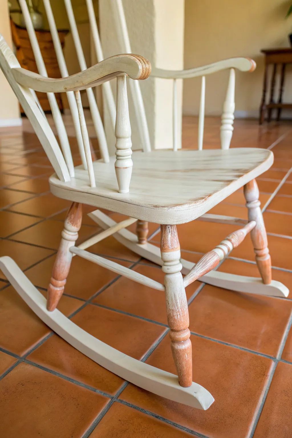 Soft ombre legs on a painted rocking chair, blending from creamy white to warm terracotta