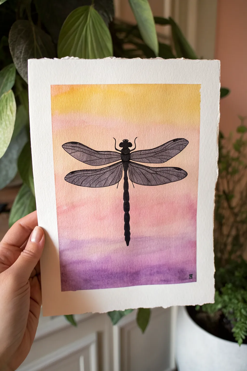 Bold black dragonfly silhouette glowing over a soft sunset gradient, simple and soothing to paint