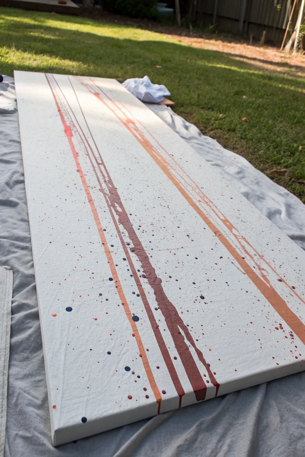 Splat-then-drip layers on a crisp white canvas, bold runs and splatters in a minimal studio.