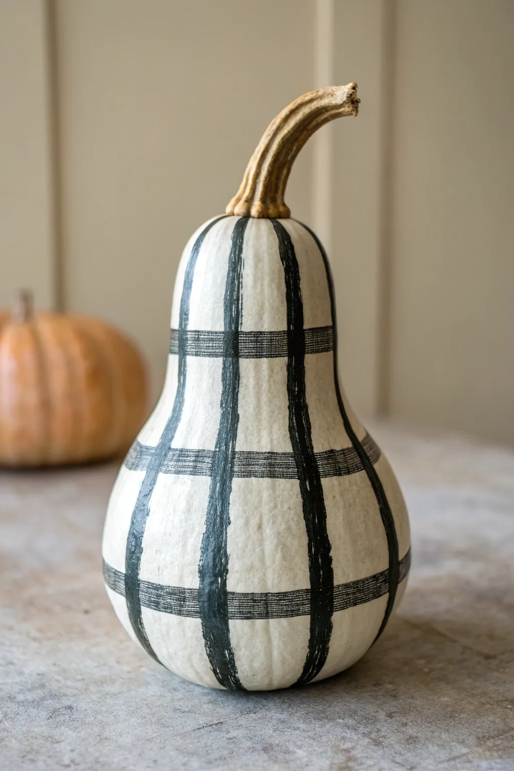 Paint a cozy buffalo plaid gourd with bold blocky stripes for minimalist fall decor.