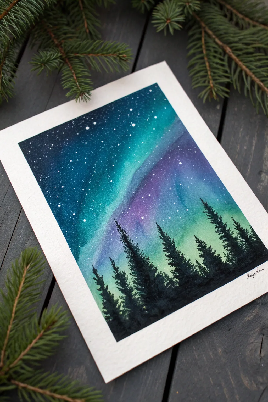 Paint a simple northern lights wash, then add white splatter stars and a bold black treeline.
