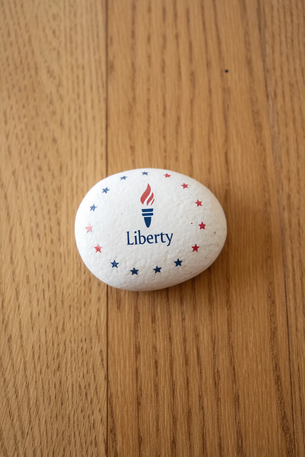 Simple liberty rock with red dots and white stars border on warm wood, clean and craft friendly