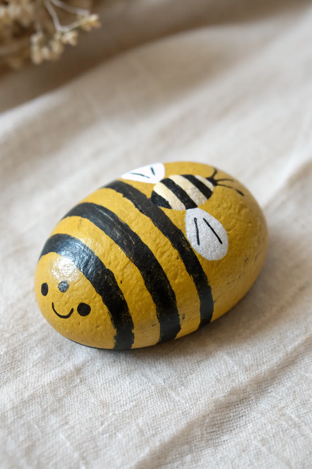Sweet bumblebee stripe rock with bold contrast and tiny wings, perfect for kids to paint