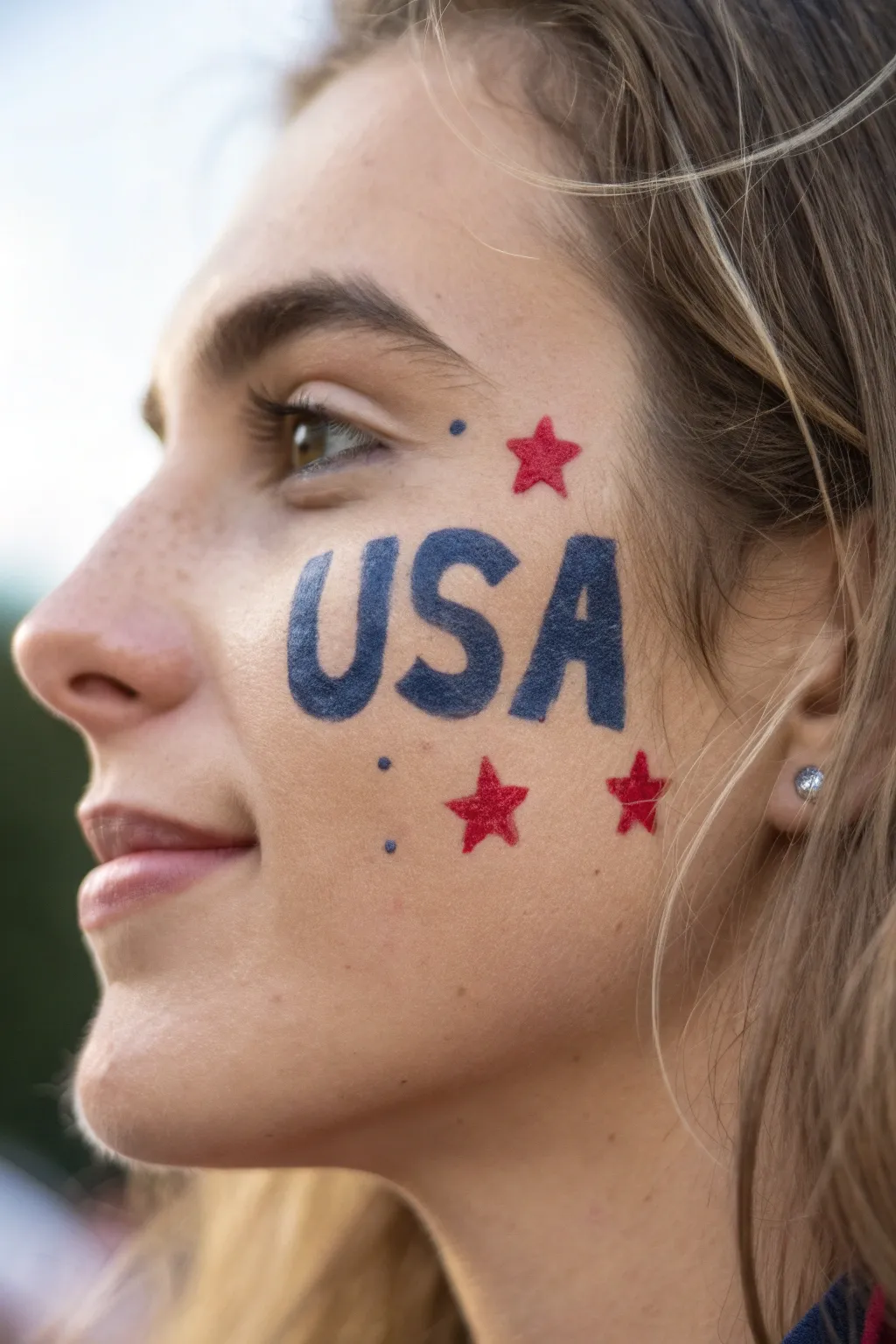 Bold USA cheek lettering with tiny stars and stripe accents, clean high-contrast Fourth of July look