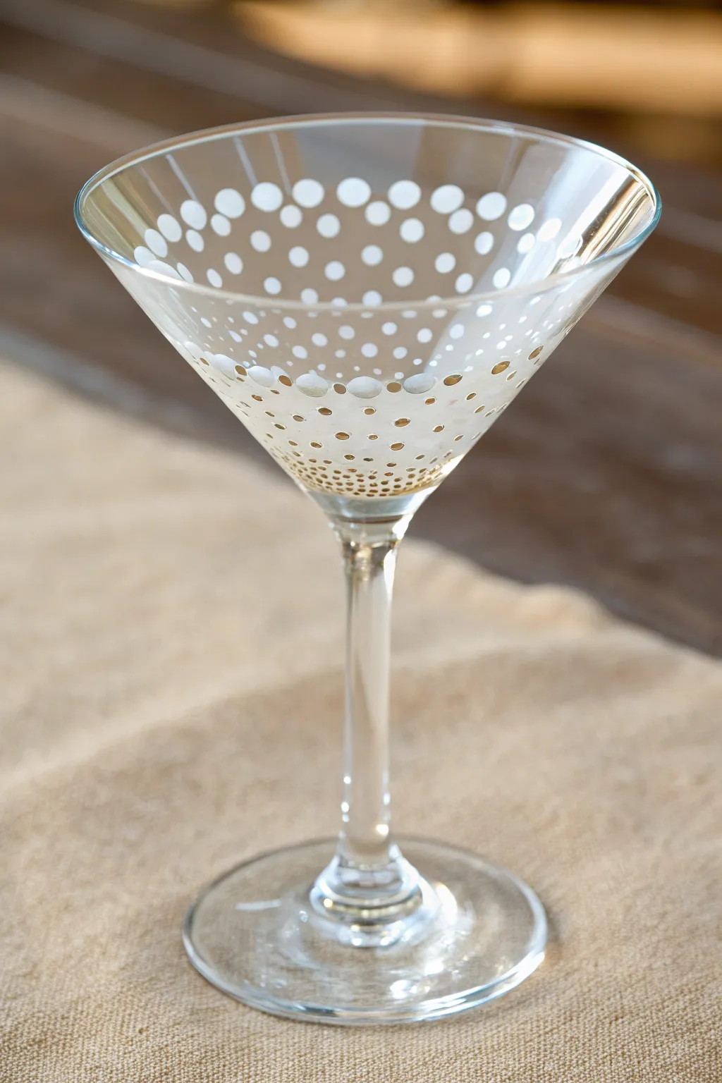 Soft ombré polka dots fading upward for a minimalist, boho-chic martini glass design.