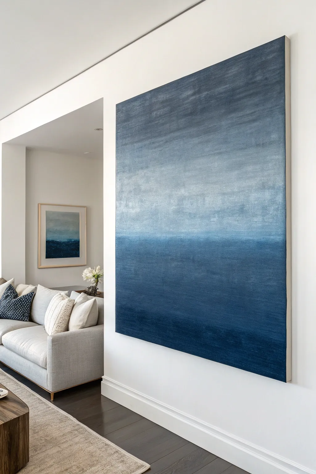 Moody blue-to-smoky gray gradient canvas brings cozy modern drama to a minimalist living room