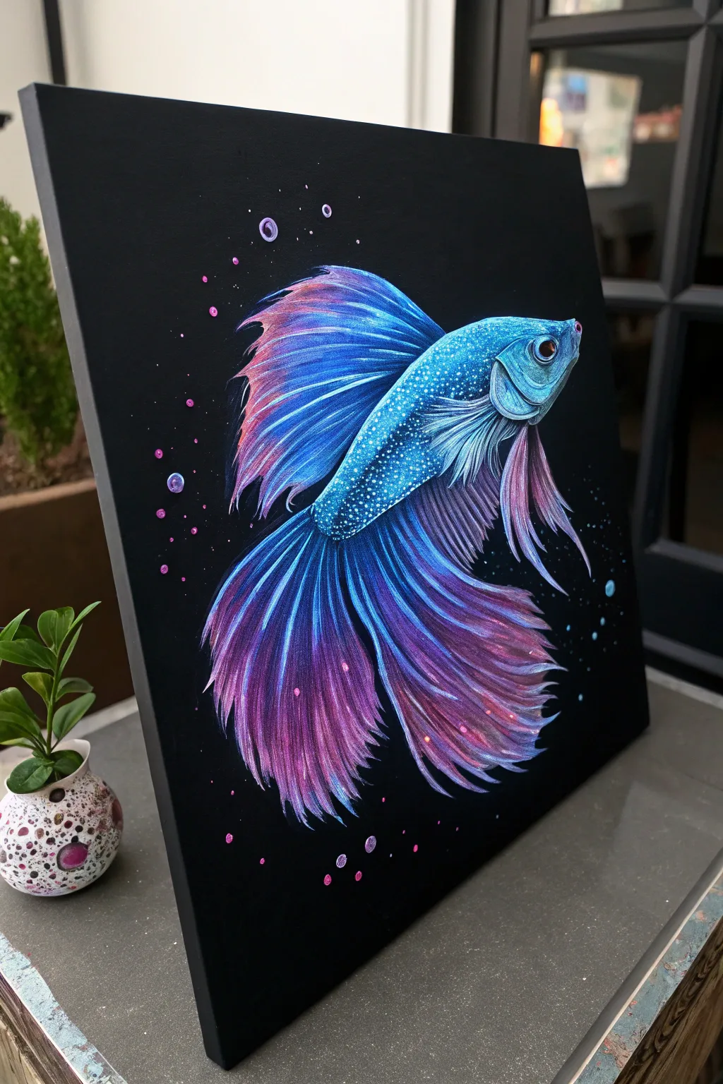 Neon betta fish on black canvas with flowing fins in radiant blue to purple gradients