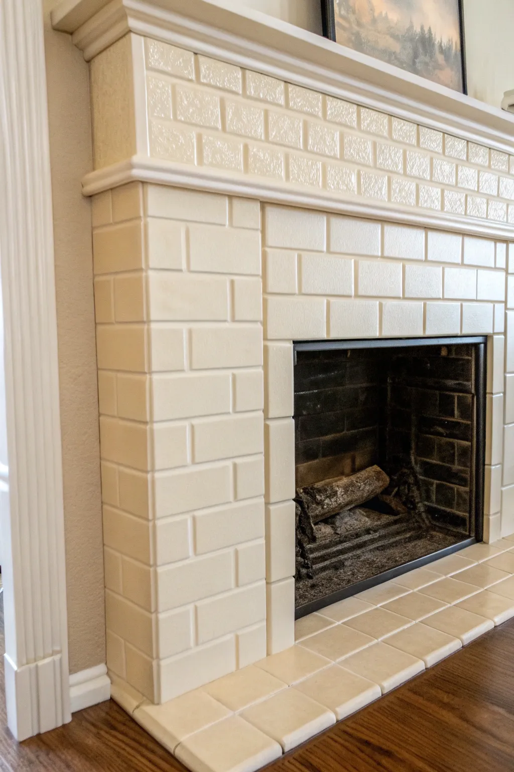 Monochrome tile and grout paint for a calm, seamless fireplace look with soft texture.