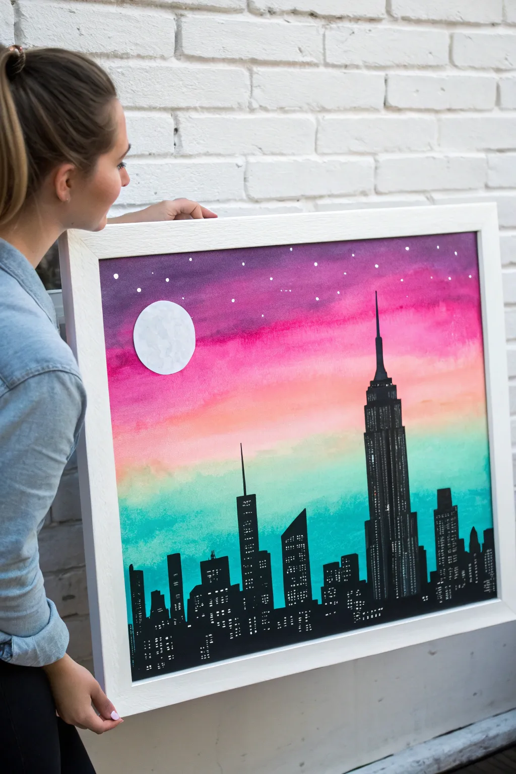 Bold black skyline silhouette pops against a neon pink purple teal sky with a simple moon.