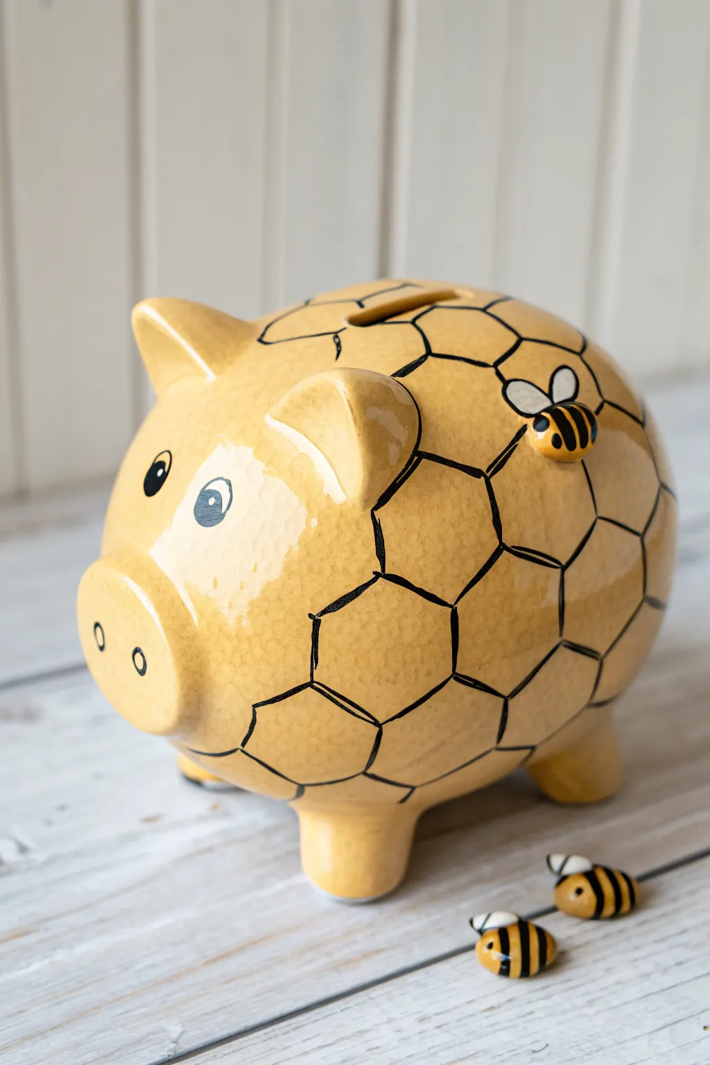 Bee-and-honeycomb piggy bank design with bold contrast and clean, handcrafted details