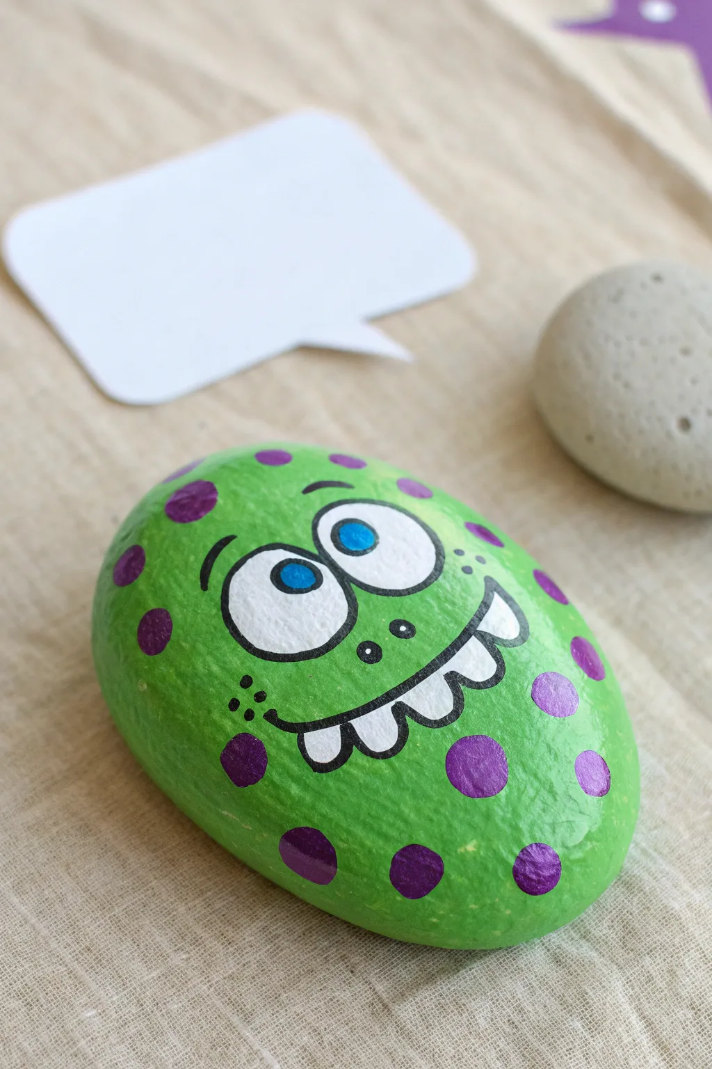 Silly monster face rock in bright colors, a playful kid-friendly painting idea for beginners