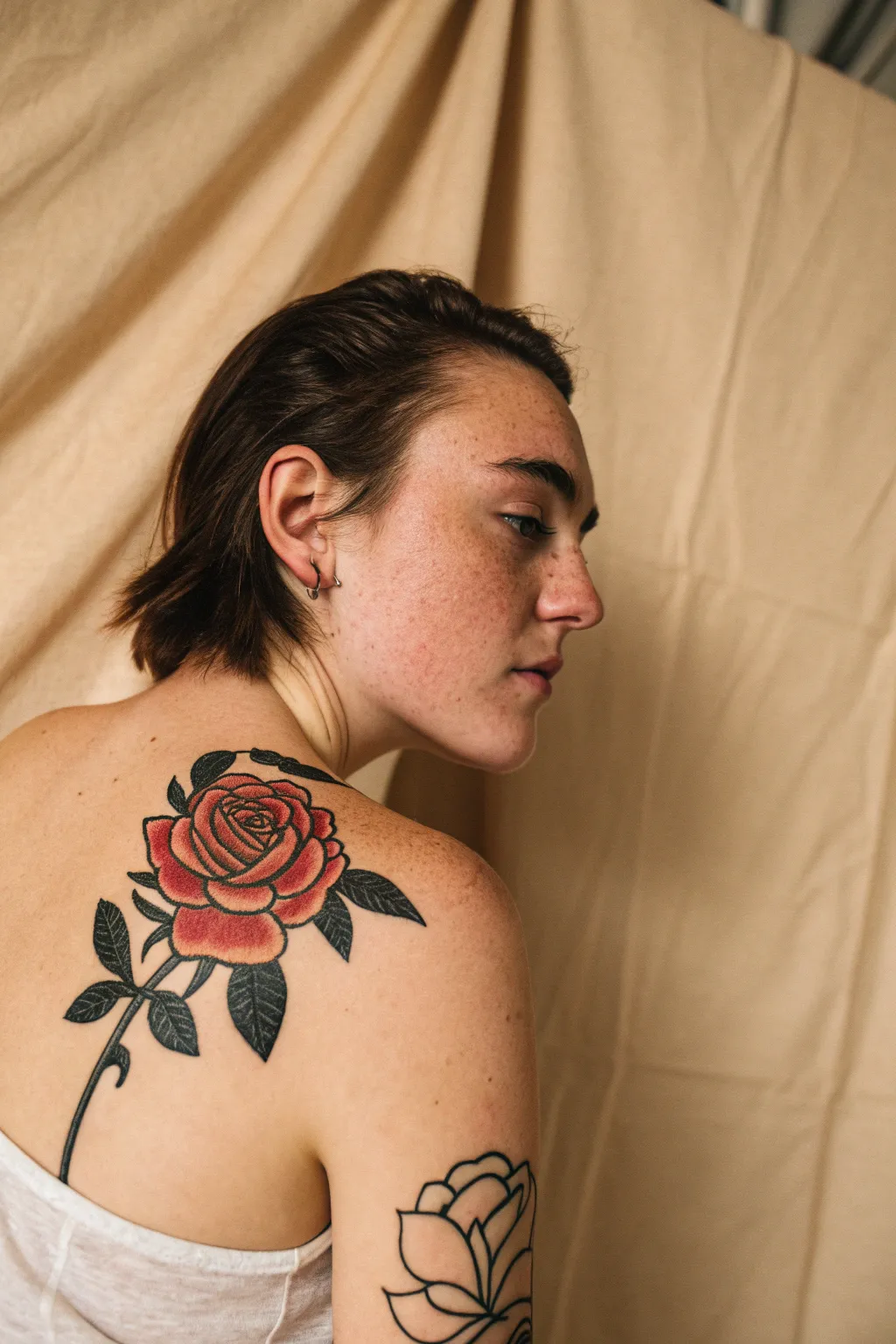 Traditional bold-outline rose shoulder mockup with flat color and punchy contrast, minimalist vibe