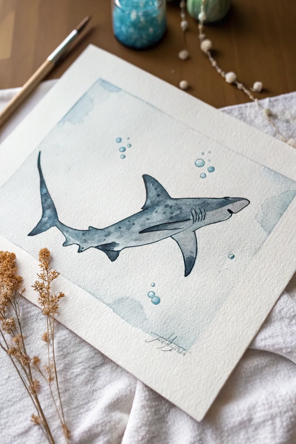 Minimalist hammerhead shark silhouette with soft shading and bubbles, calm and bold.