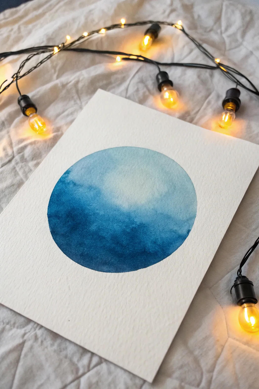 Capture the cozy magic of twilight with this simple glowing string lights painting.
