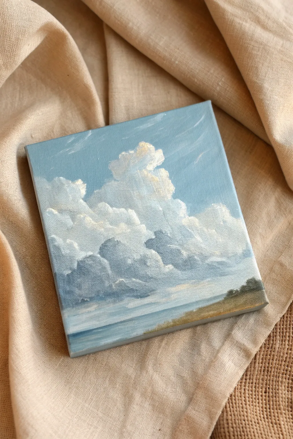 Palm-sized cloud study in soft blues and grays, simple shapes and gentle blending.