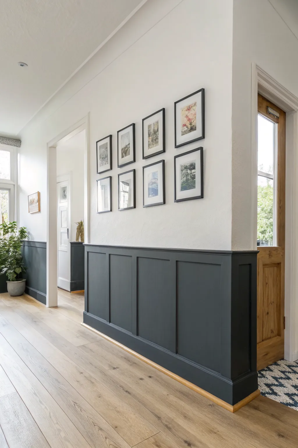 Bold split wall paint: airy white above, deep charcoal below, framed accents for drama.