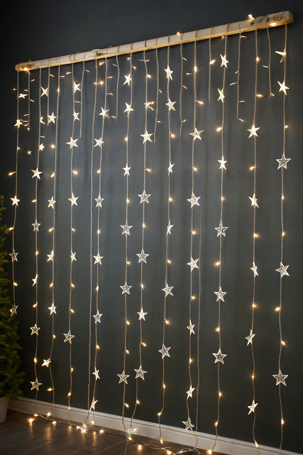 Fairy light star curtain creating a wall of warm stars, perfect minimalist stage backdrop