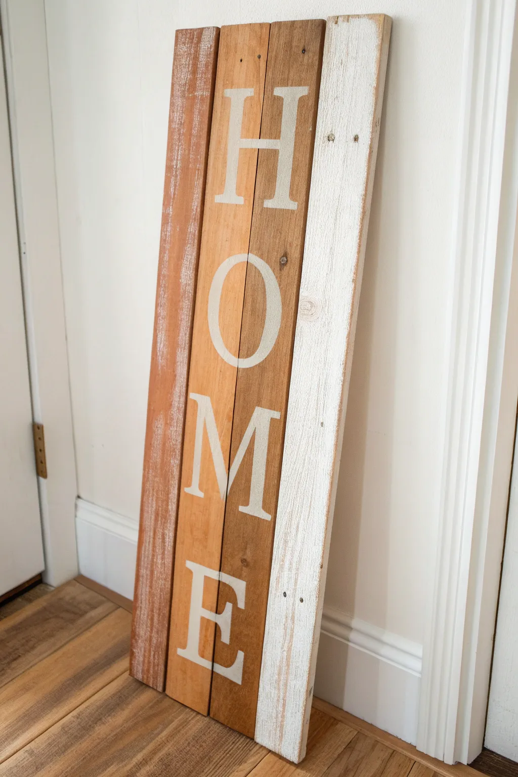 Painted stripe plank sign with stencil-style details, a simple rustic wood craft for beginners.