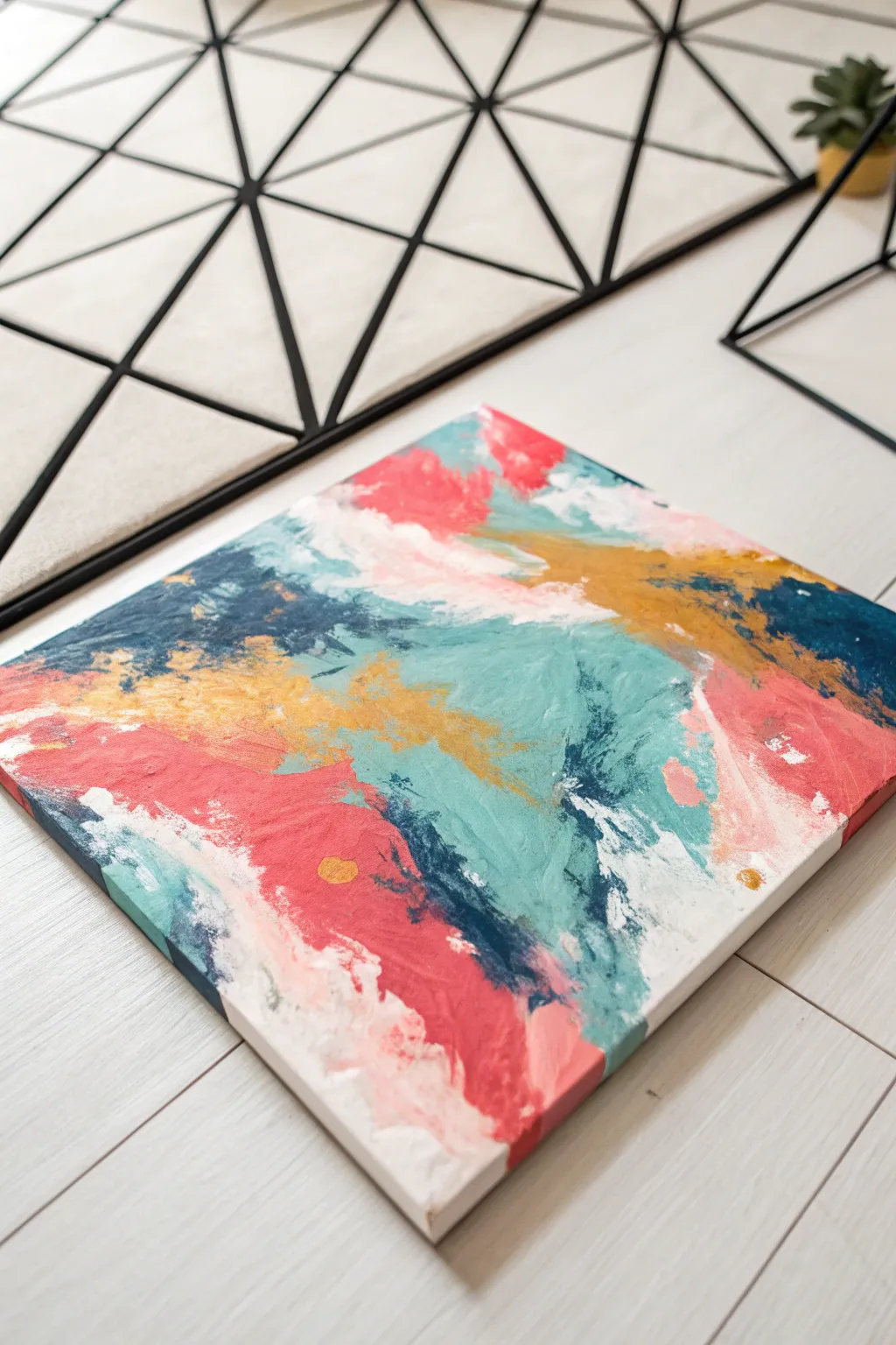 Bold black grid over wild acrylic underpainting, a minimalist-boho abstract painting to try today.