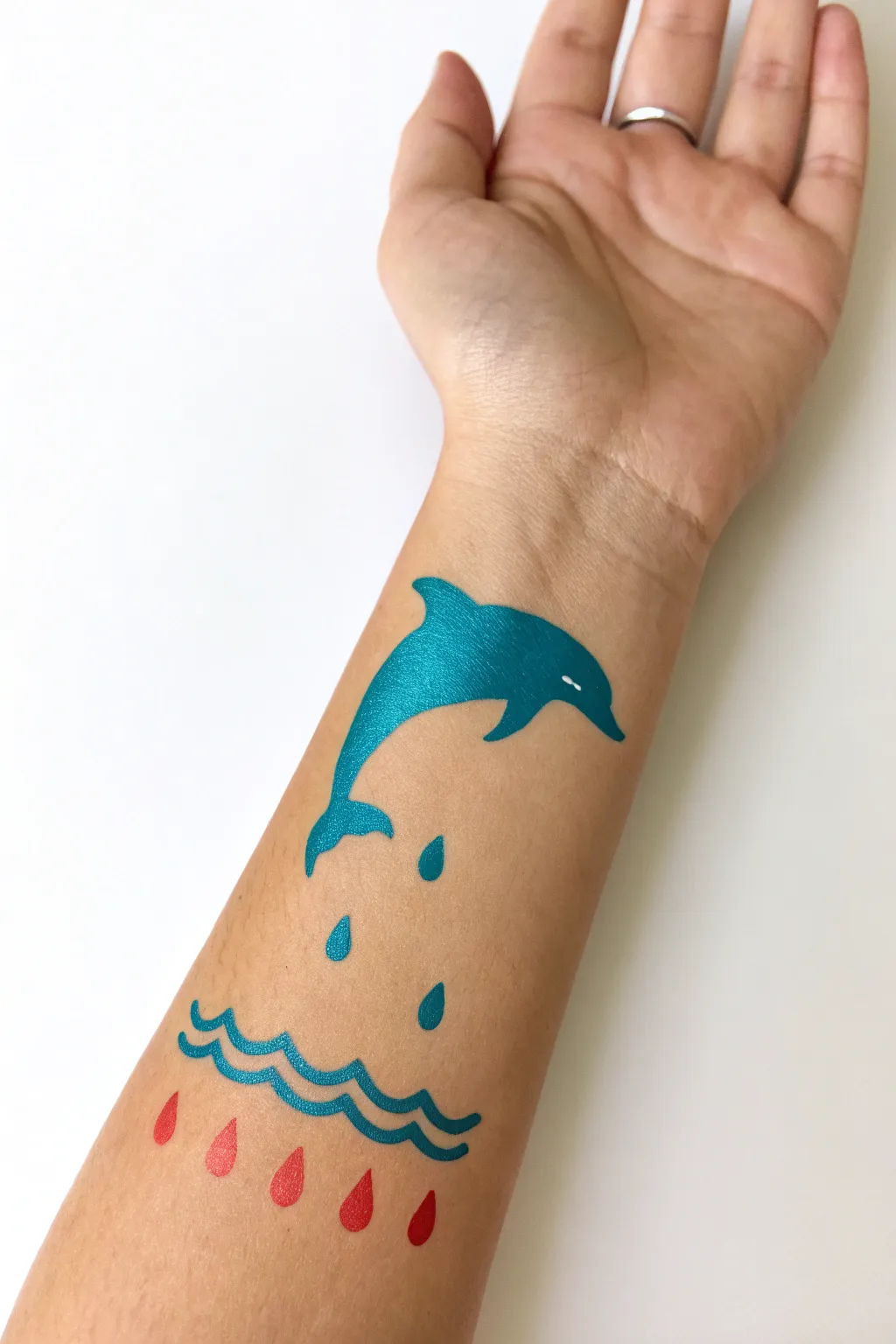 Easy dolphin forearm paint idea with bold splash lines for a clean Scandinavian-boho look