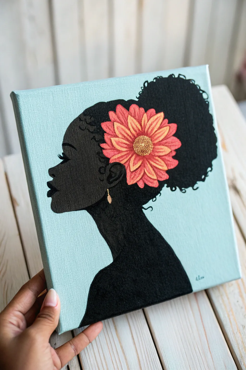 Simple afro puff silhouette with a bold flower accent, minimalist boho color pop