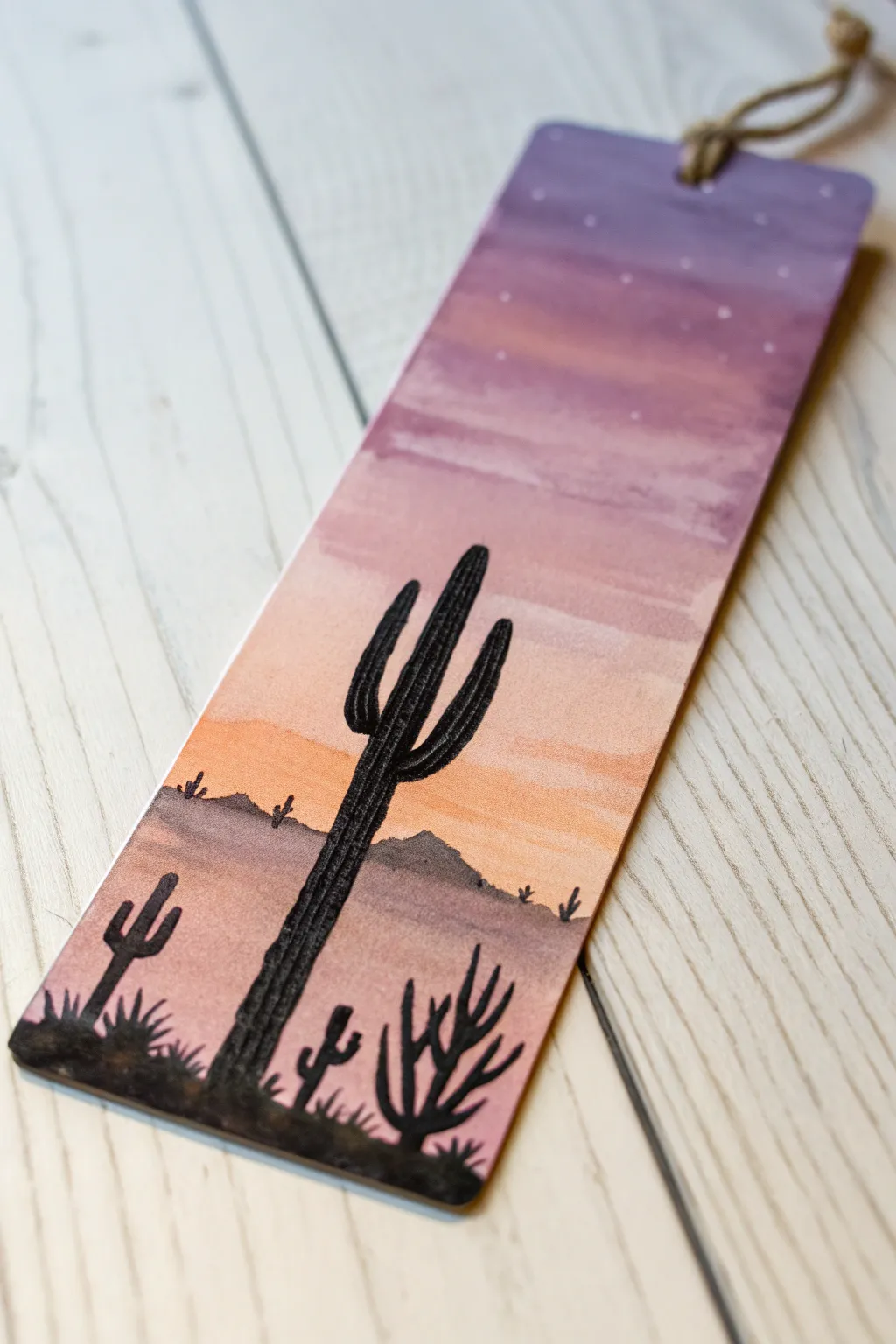 Acrylic bookmark idea: bold cactus silhouettes over a peach-to-violet desert sunset gradient