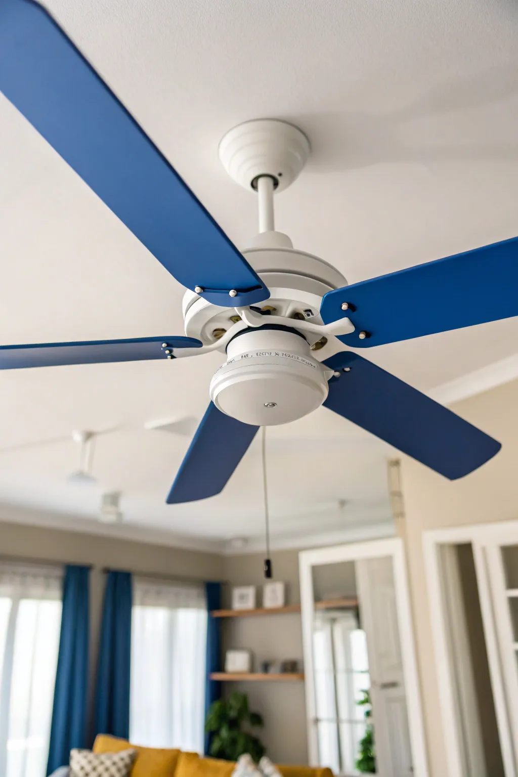 Bold solid-color fan blades with a calm neutral housing for a modern, playful ceiling pop.