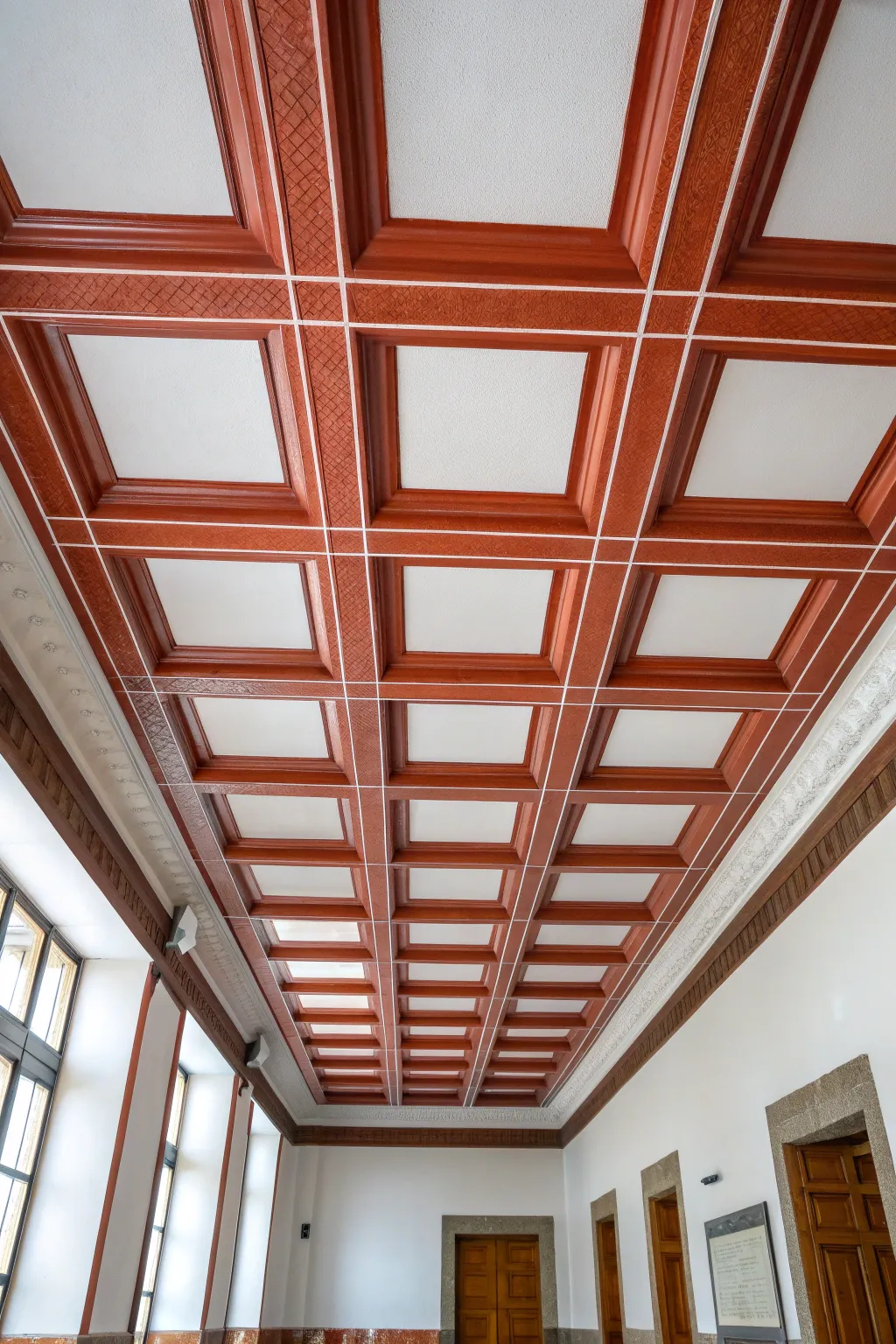Painted terracotta tile border frames the ceiling for a crisp, modern room outline.