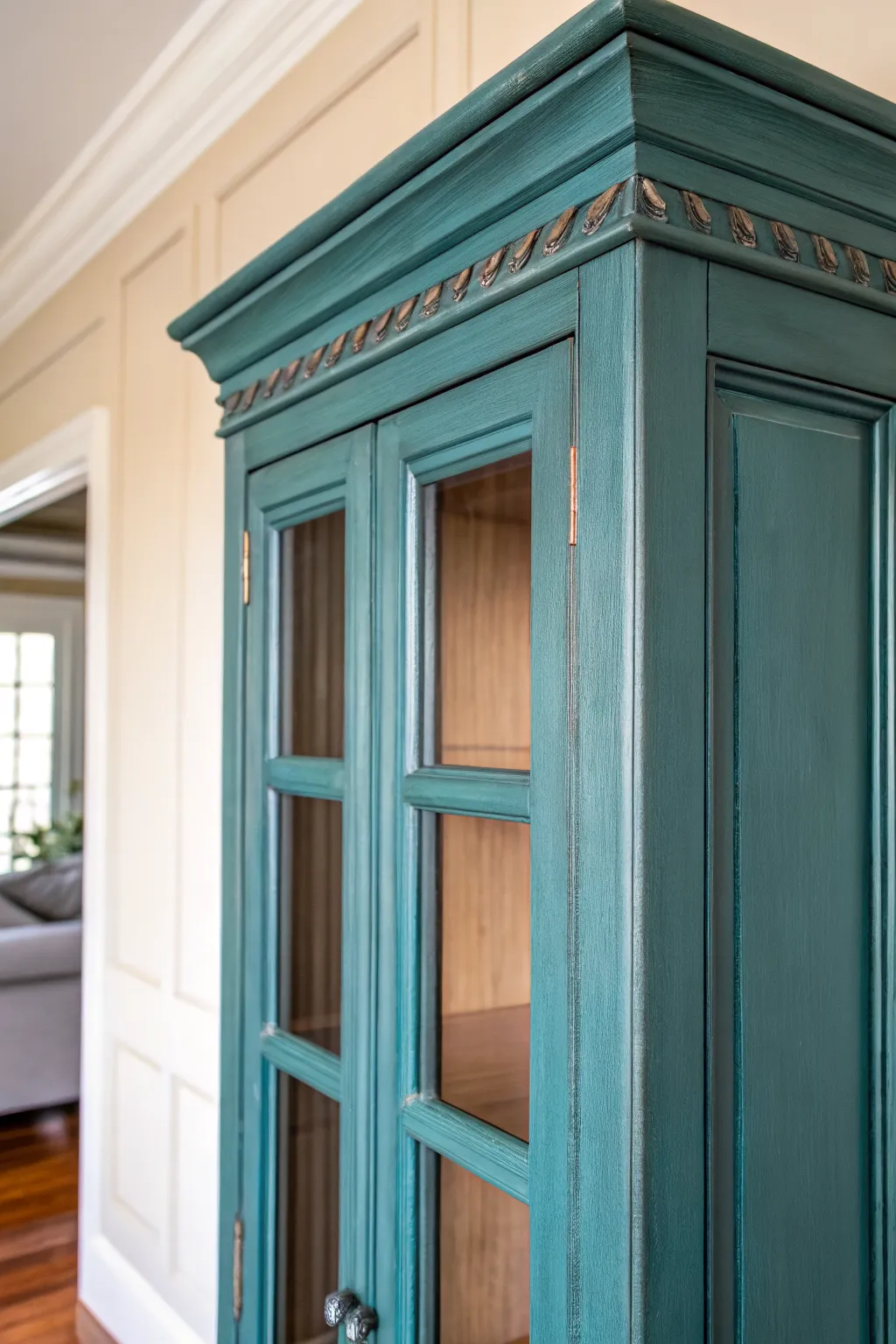 Classic distressed edges on a chalk-painted china cabinet with bold color and warm wood peeking through