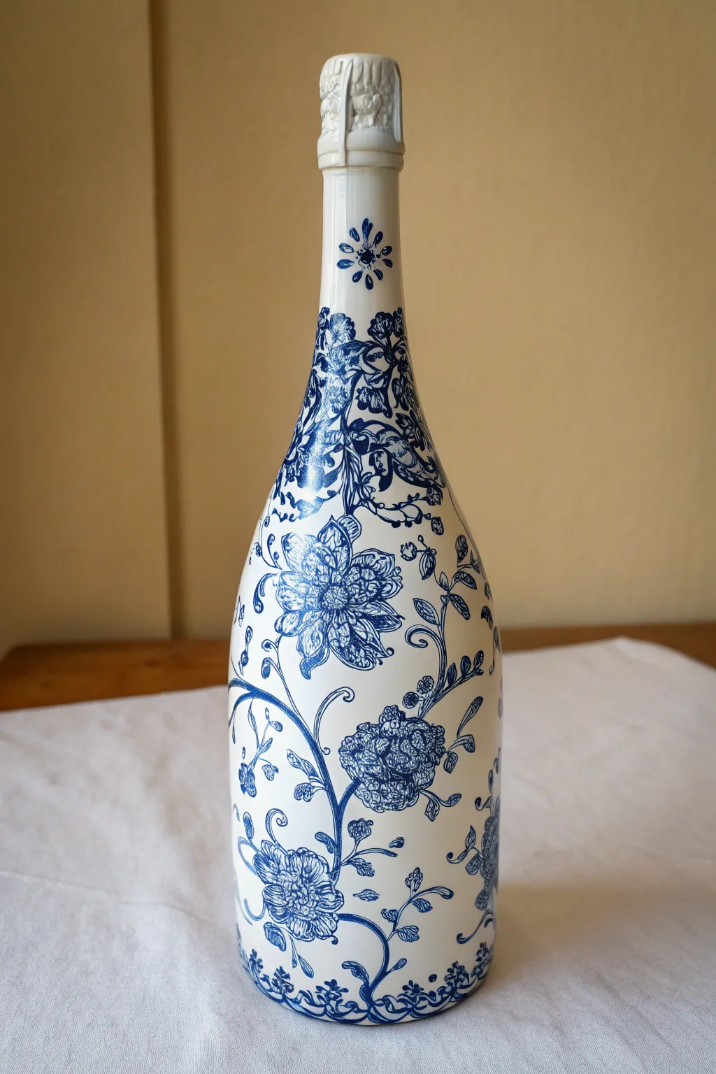 Blue-and-white porcelain-style painted champagne bottle that looks like a chic ceramic vase