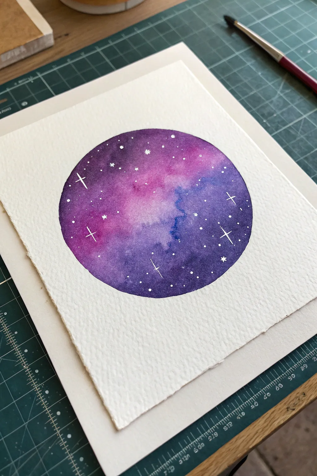 Masked circle galaxy wash with splatter stars for an easy, dreamy circle painting idea
