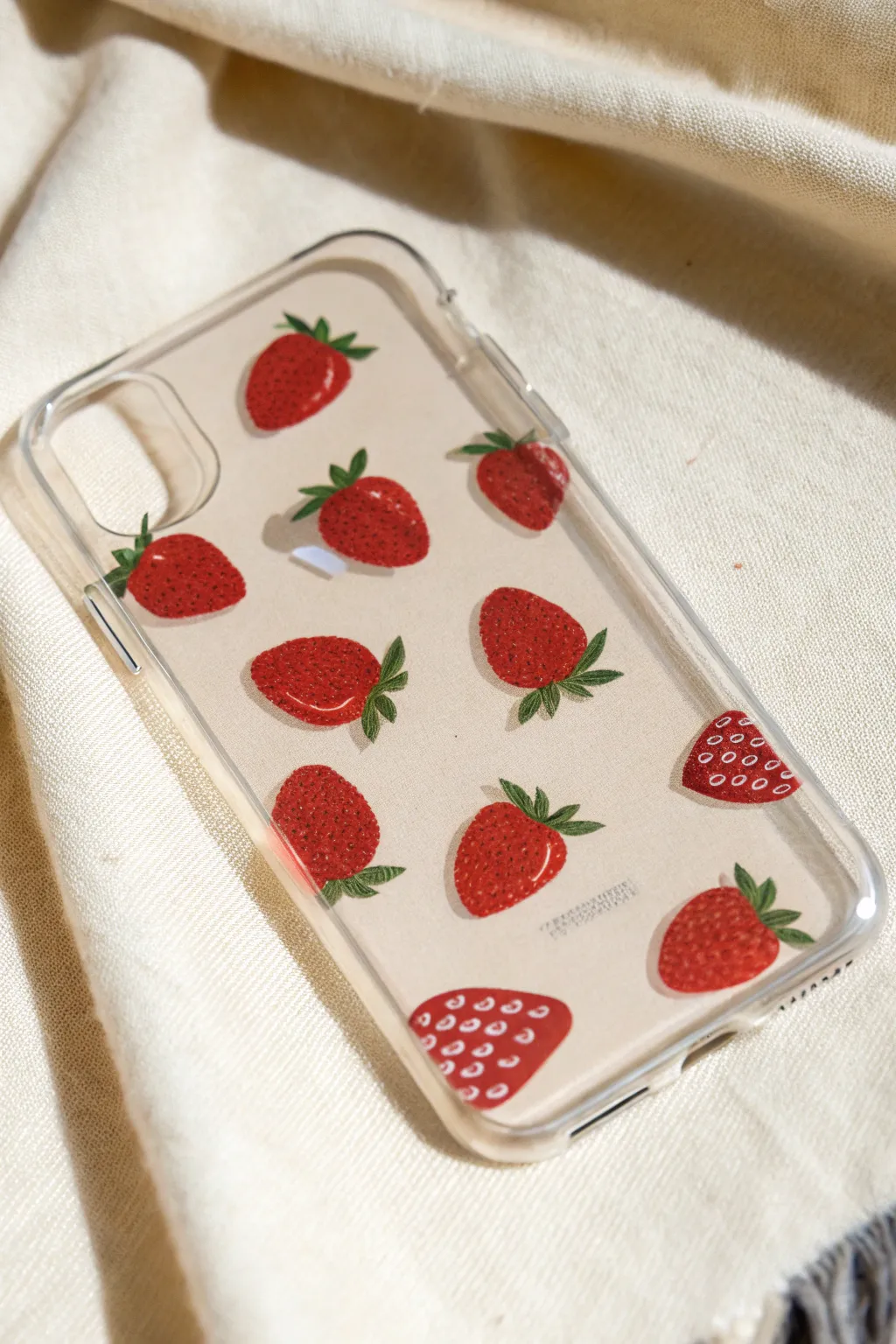 Clear phone case painted with cute strawberry icons and leafy caps for a minimalist boho look