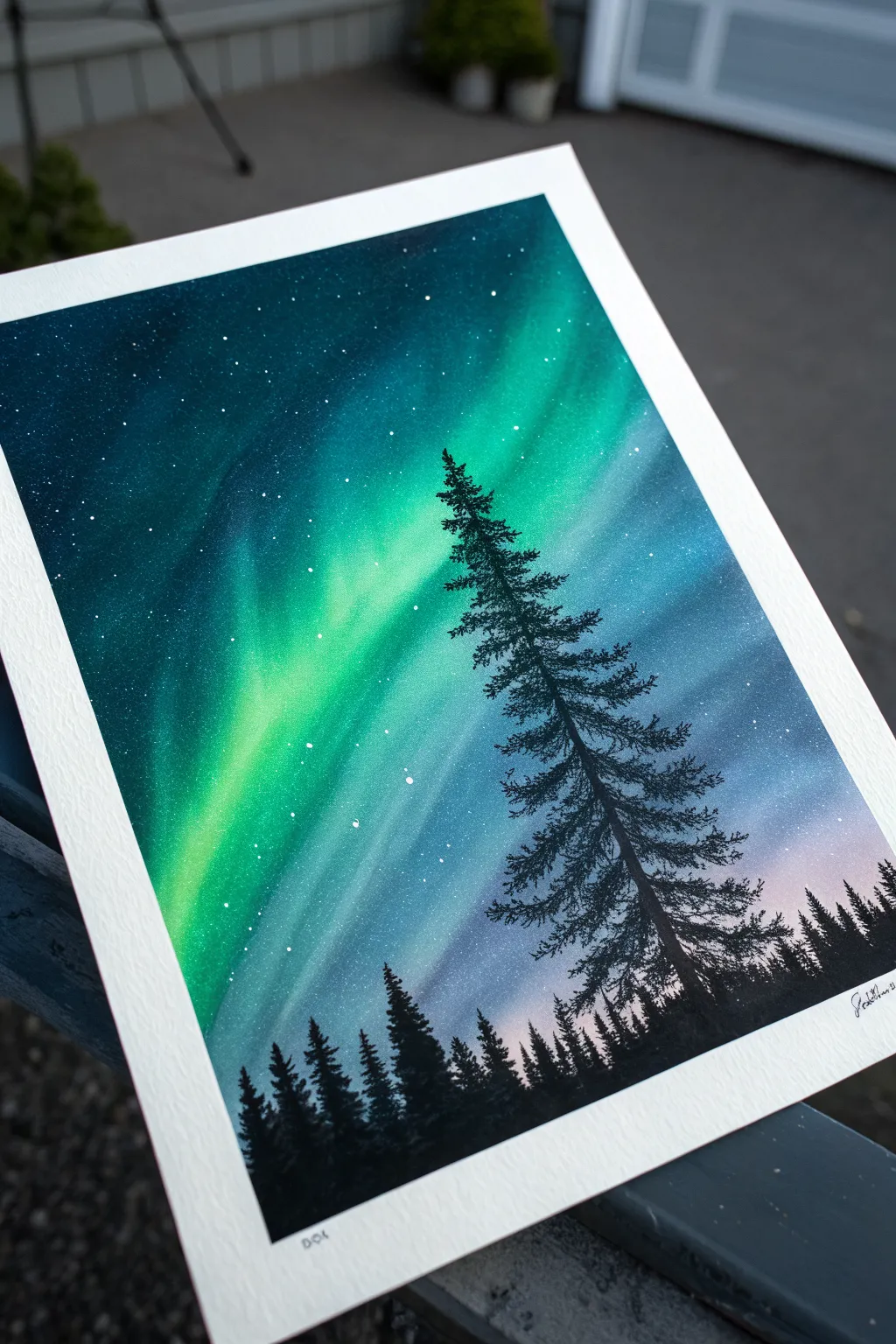 Easy airbrush idea: glowing northern lights ribbons above a crisp pine silhouette on a dark sky