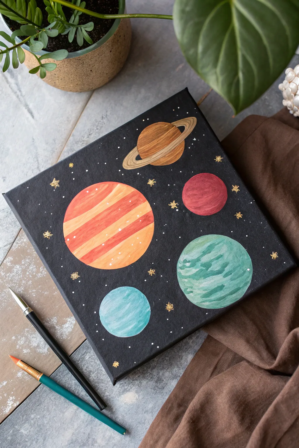 Minimalist space painting with bold planets and delicate orbits on a deep night-sky backdrop.