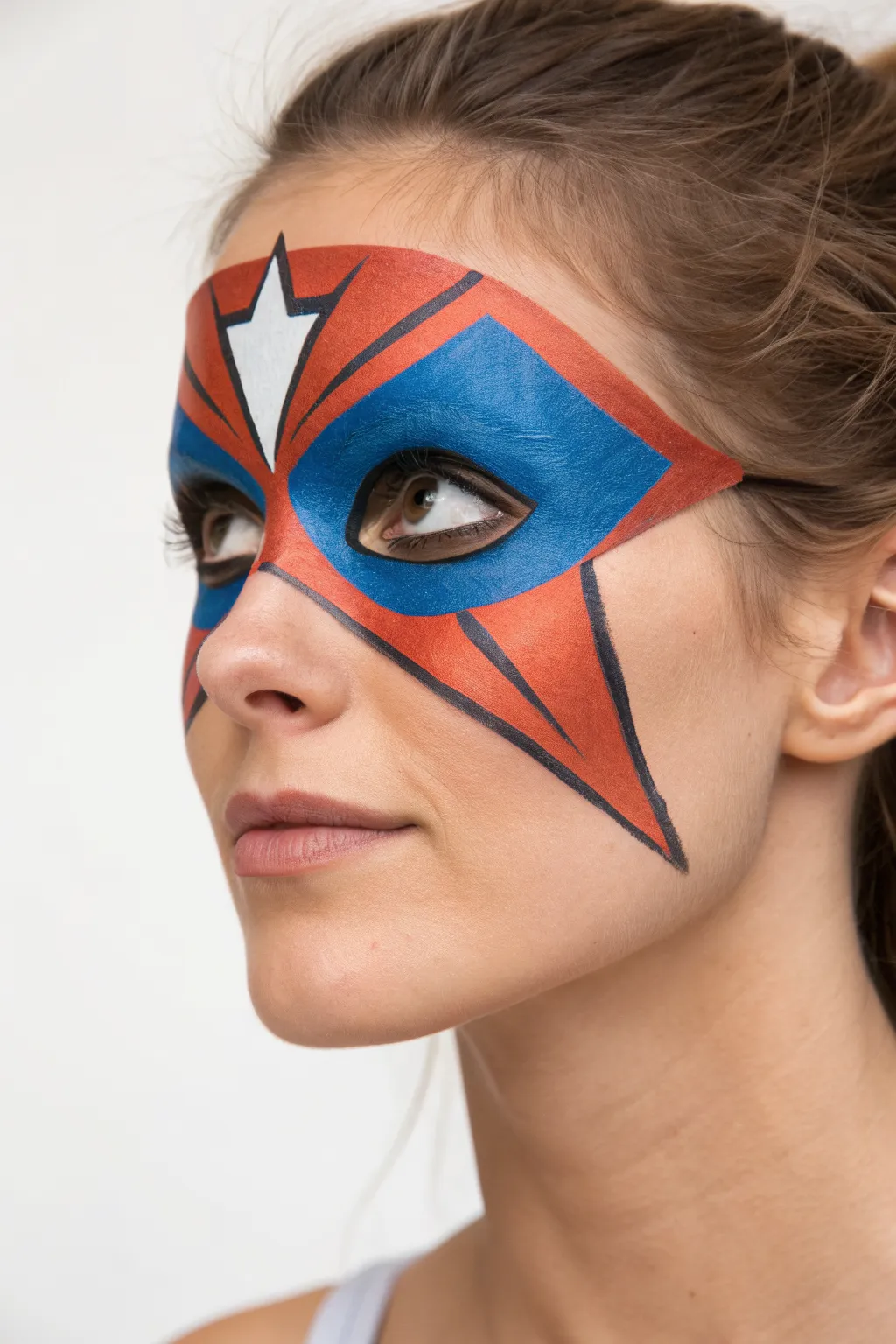 Superhero eye mask face paint with bold color blocks, sharp edges, and comic-style speed lines